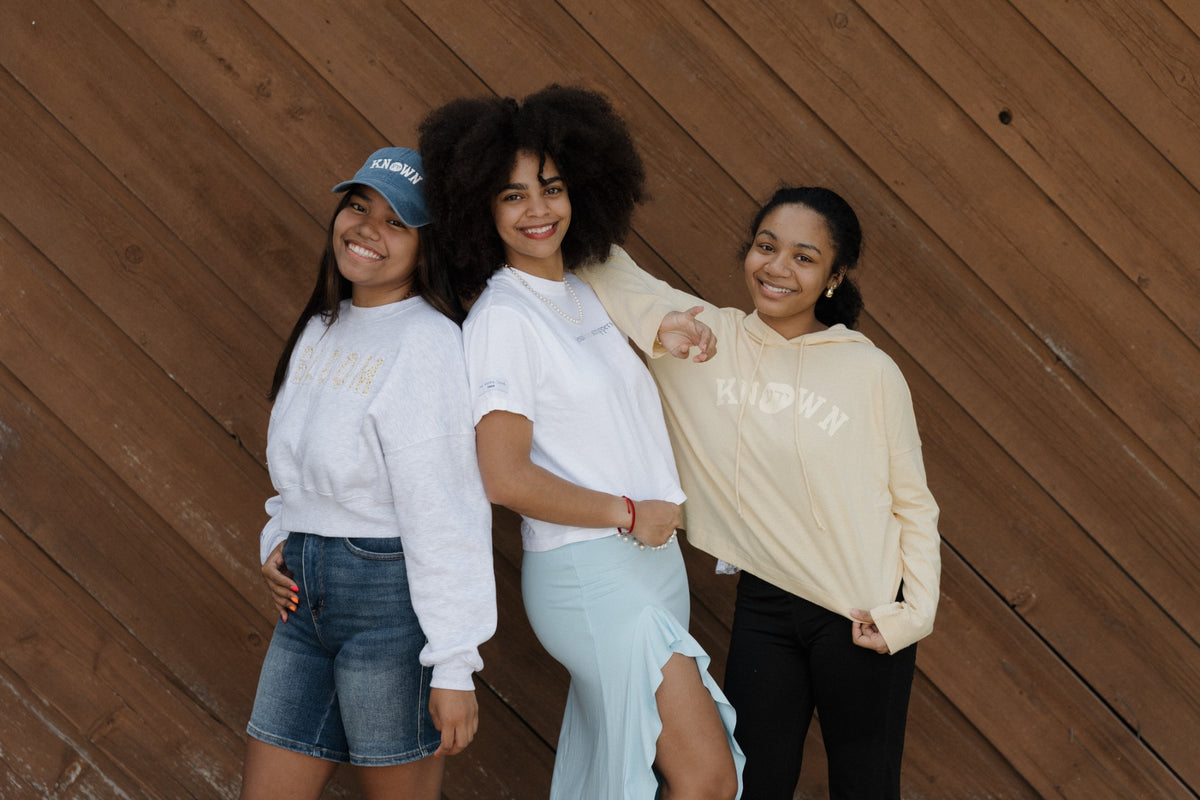 Three women smiling together in Yada apparel