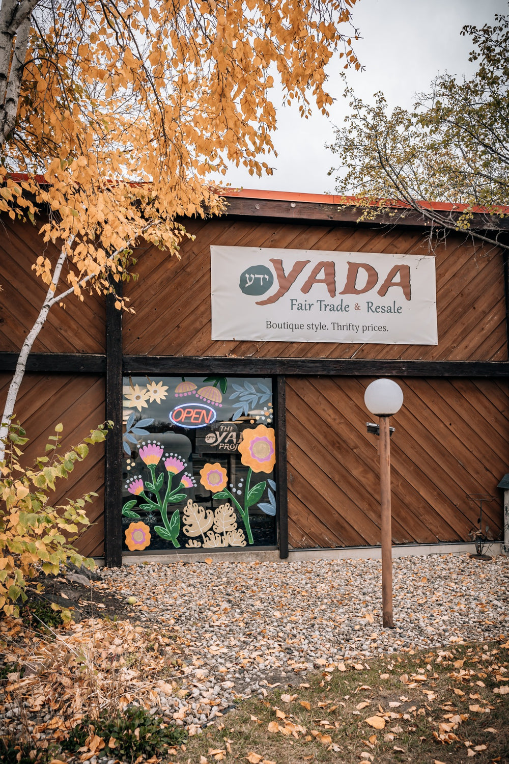 Yada Fair Trade & Resale storefront in Middleton, Wisconsin, with autumn leaves and a floral window